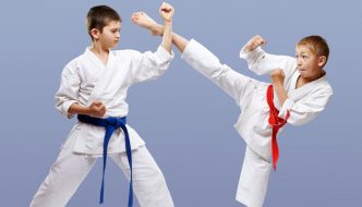 boys practicing kicking in martial arts class