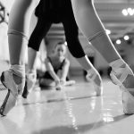 black and white photo of ballerinas wearing pointe shoes