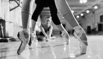 black and white photo of ballerinas wearing pointe shoes