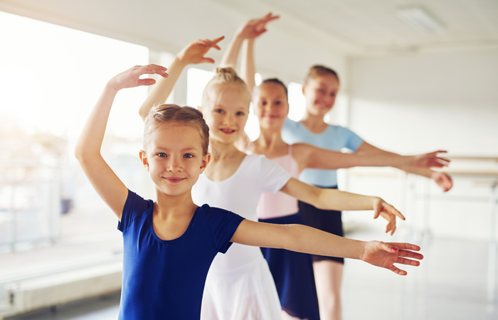group of young ballerinas smiling during class