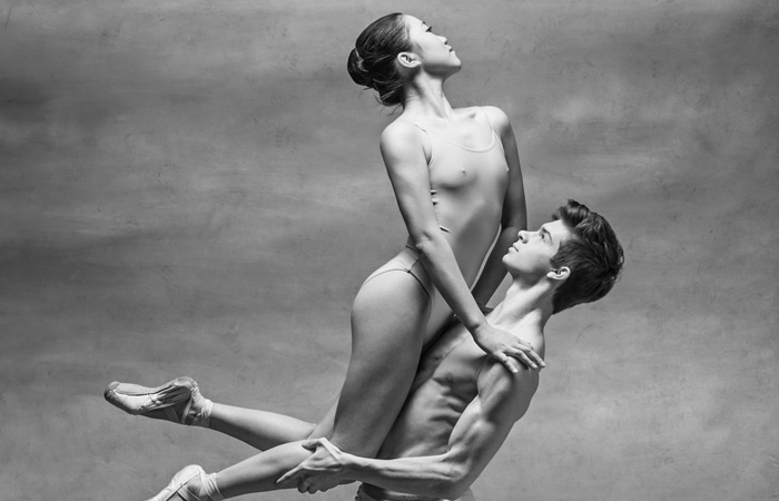 male dancer holding up female dancer during performance