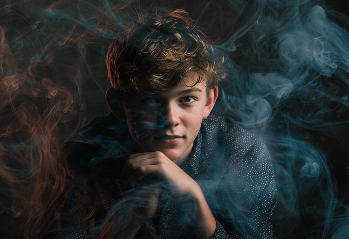 teen boy with smoke and lights effects for creative senior portrait