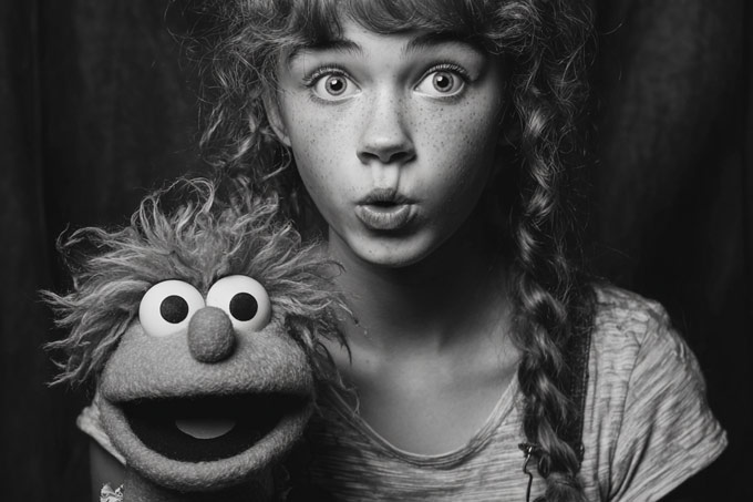 black and white portrait of puppet with teen girl ventriloquist
