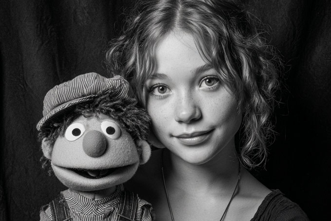 high school girl ventriloquism student posing in black and white portrait with puppet