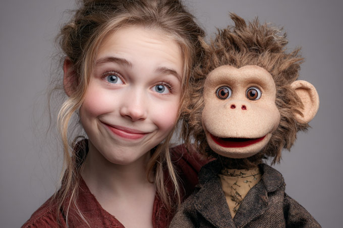 young high school girl ventriloquist with her monkey vent figure